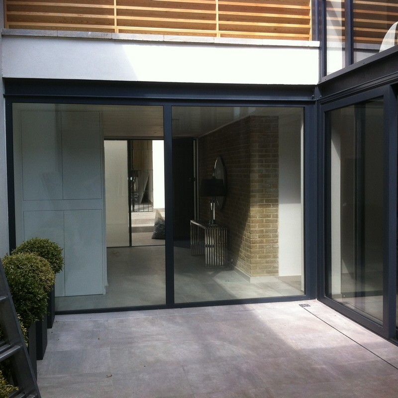 Floor-to-ceiling sliding doors opening to courtyard in London