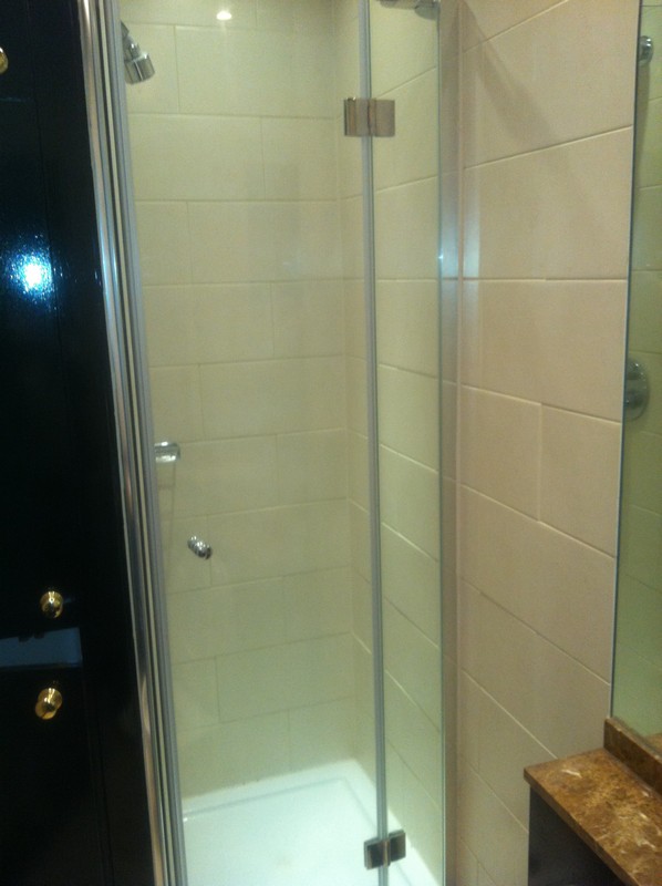 Frameless glass shower enclosure with chrome fittings in London