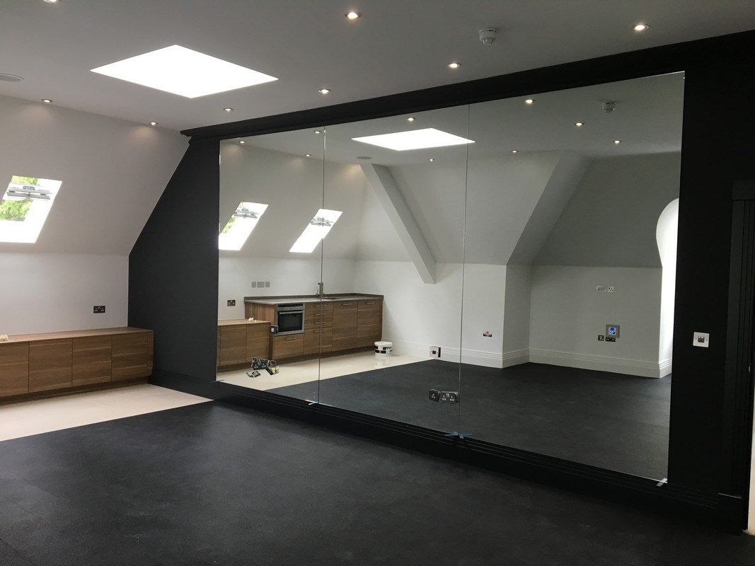 Frameless glass wall dividing loft conversion in London