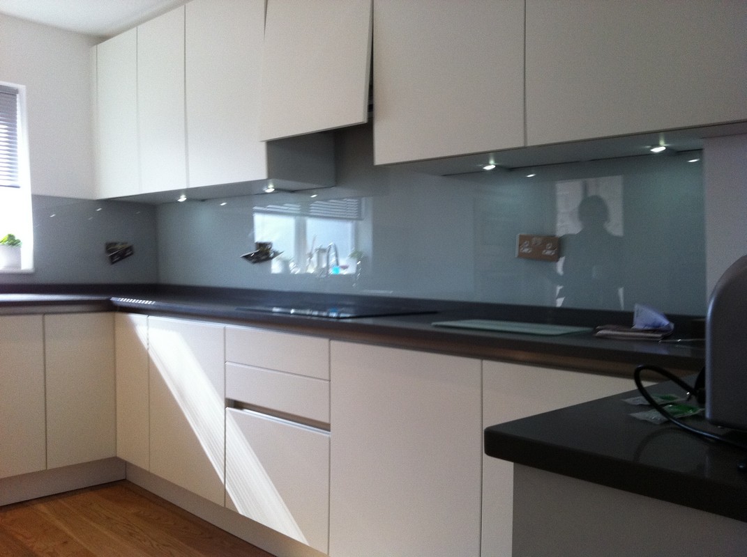 Grey glass kitchen splashback with LED lighting in London