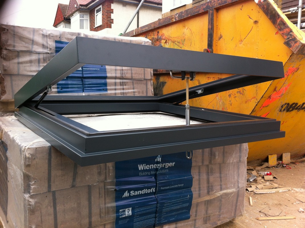 Opening flat roof skylight in anthracite grey installed in London