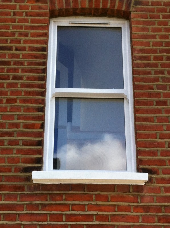 uPVC sash window on Victorian red brick house in London